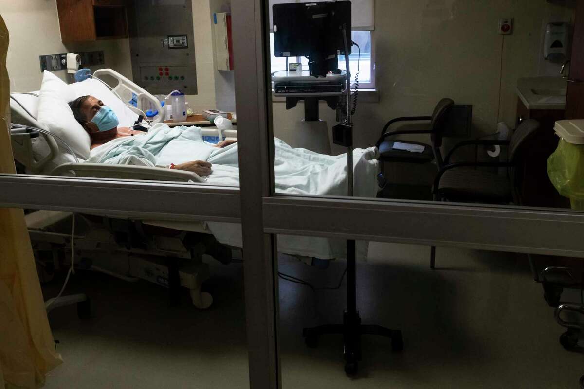 COCID-19 patient Jorge Zambra, 70, lays down in his Memorial Hermann-Texas Medical Center bed on Thursday, July 2, 2020, in Houston, as he speaks using a tablet on a stand about the care he has received at the hospital. Zambra is being cared for at an intermediate care section of the hospital.