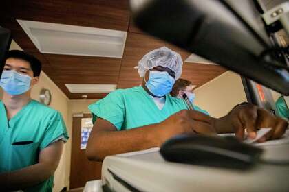 UTHealth internal medicine doctor Messan Folivi doing his residency works in the Memorial Hermann-Texas Medical Center COVID-19 intensive-care unit on Thursday, July 2, 2020, in Houston.