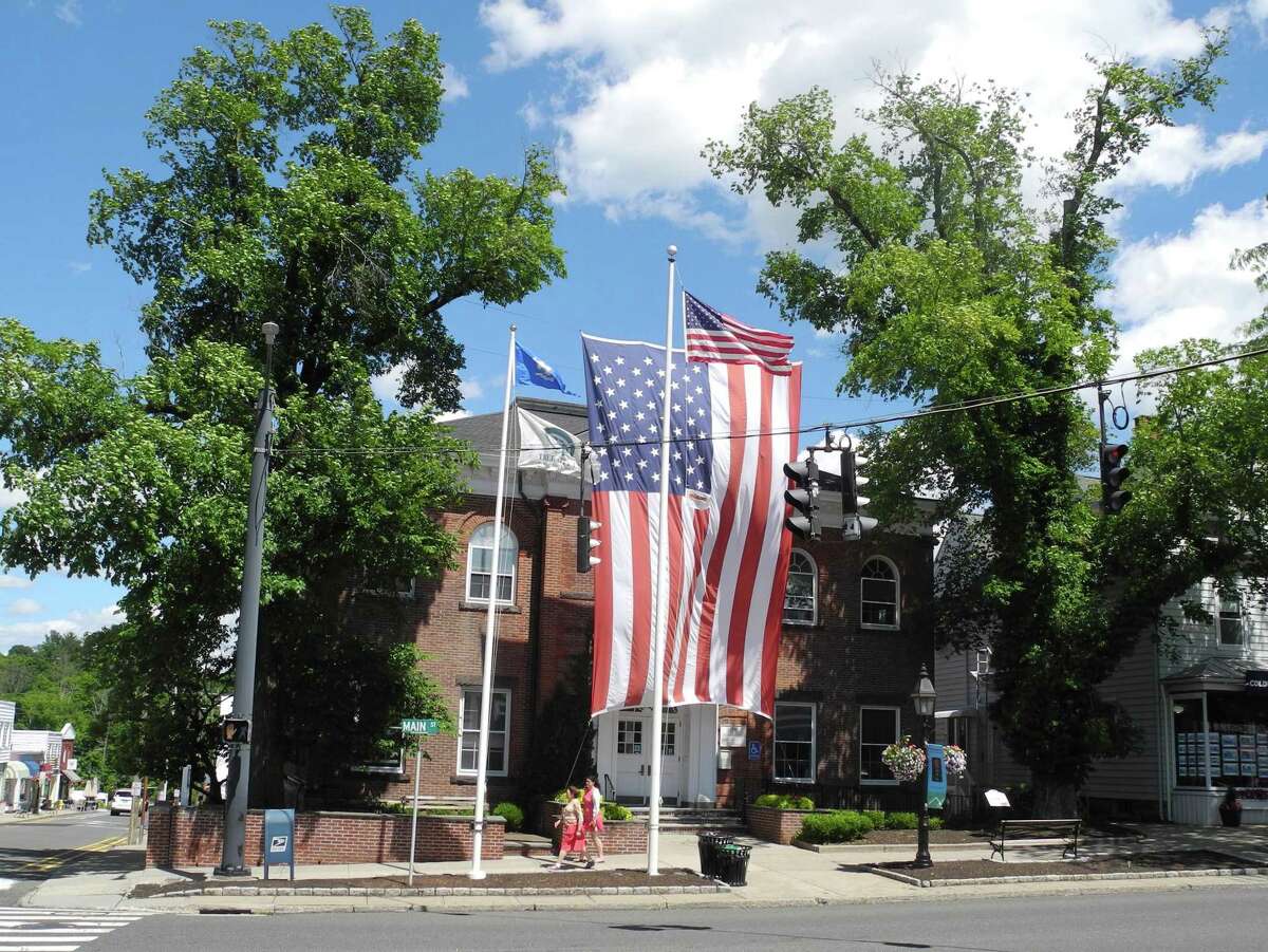 A giant American flag drapes the front of Ridgefield Town Hall on June 25, 2018. The flag has not been hung since two elm trees that supported it were removed later that month.