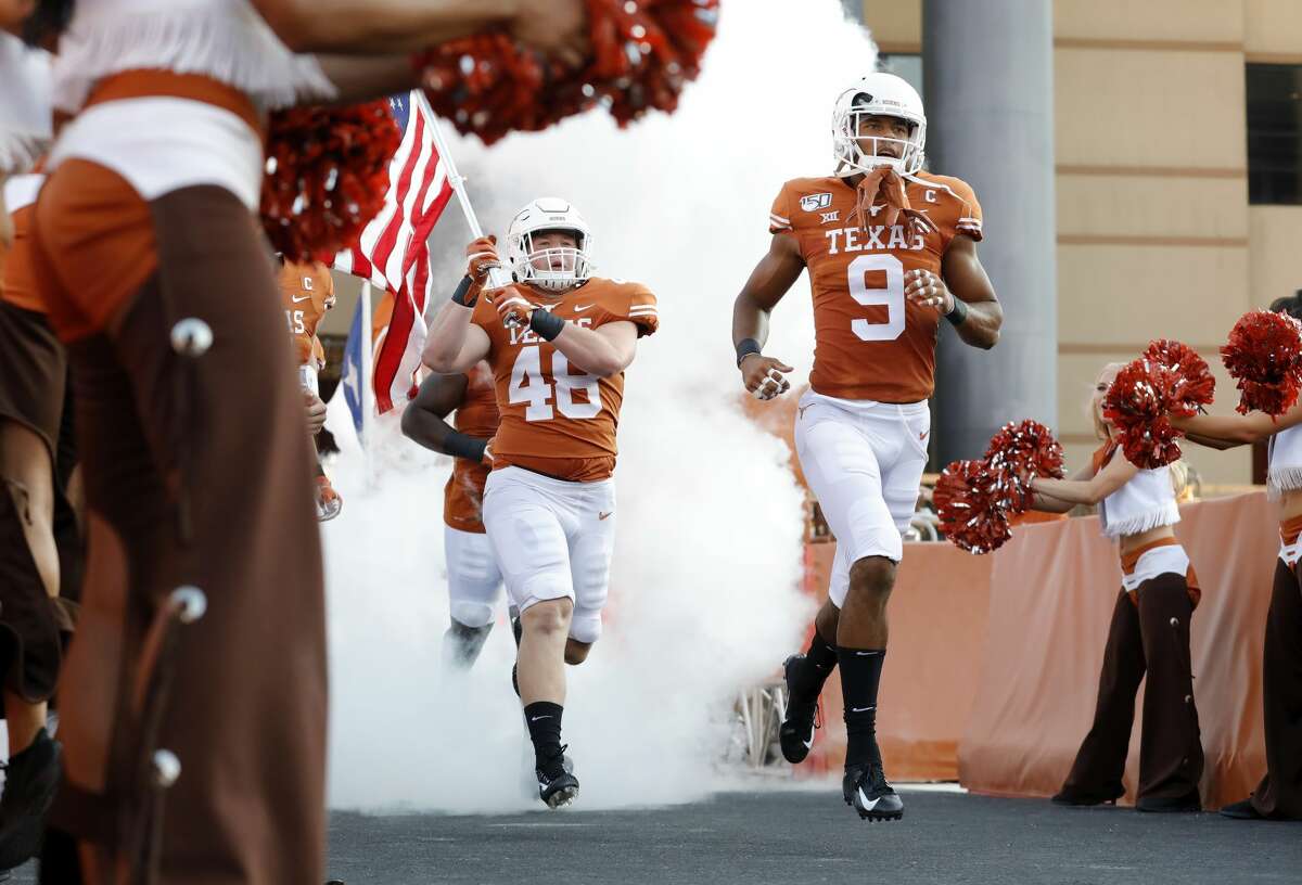 Collin Johnson #9 of the Texas Longhorns and Jake Ehlinger #48 enter the stadium before the game against the Louisiana Tech Bulldogs at Darrell K Royal-Texas Memorial Stadium on August 31, 2019 in Austin, Texas.