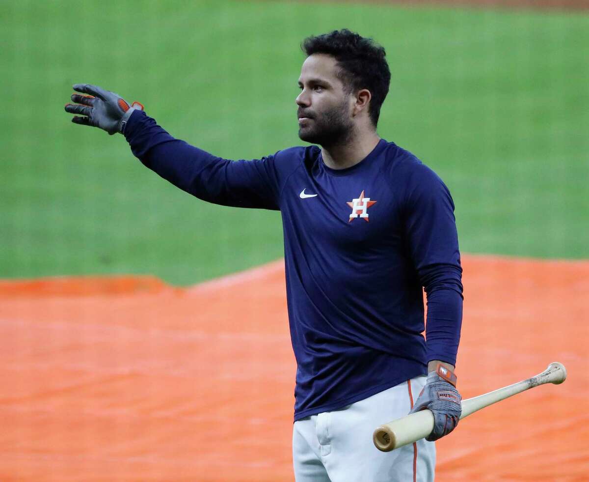 Houston Astros' L.J. Hoes takes his helmet off after arriving in the dugout  on teammate Jose Altuve's two-run double during the fifth inning of a  baseball game against the Detroit Tigers in