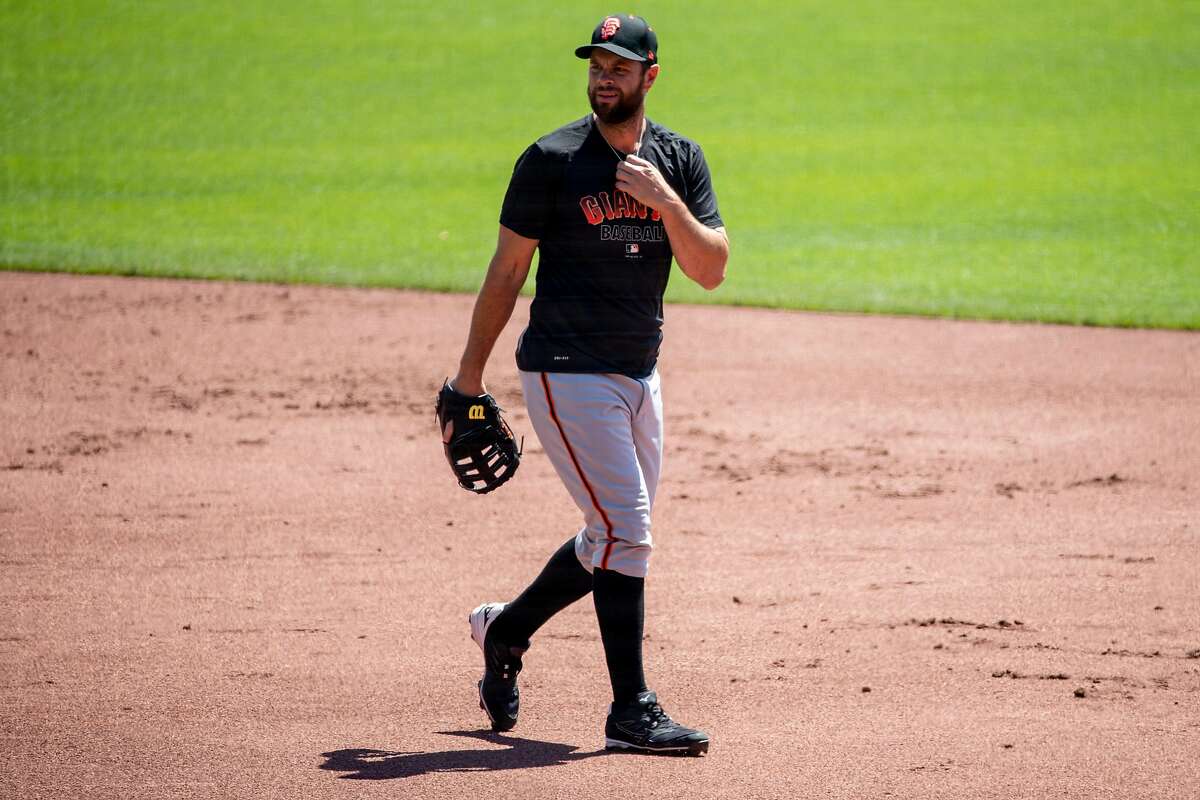 San Francisco Giants infielder Brandon Belt (#9) walks on the field while warming up during the San Francisco Giants' summer training camp session at Oracle Park in San Francisco, Calif. Saturday, July 4, 2020. Due to COVID-19, the 2020 MLB season has been postponed with players just beginning to return for warmups and practices while wearing masks and keeping social distance.