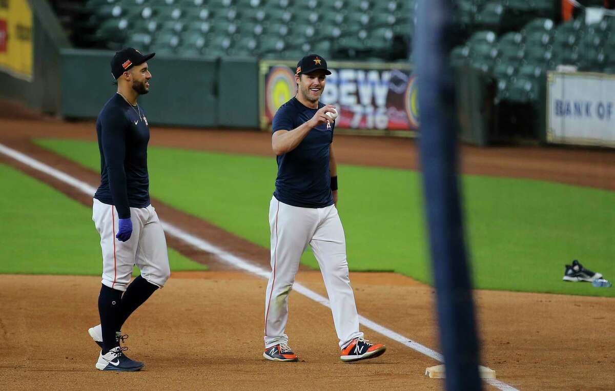 Houston Astros outfielders George Springer and Josh Reddick heading back to the dugout during the Astros summer camp Sunday, July 5, 2020, at Minute Maid Park in Houston.
