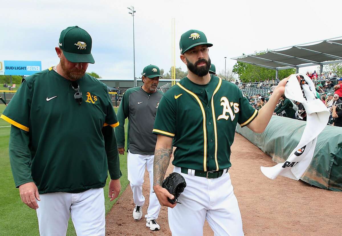 MESA, ARIZONA - MARCH 10: Pitcher Mike Fiers #50 of the Oakland Athletics walks to the dugout during the MLB spring training game against the Kansas City Royals at HoHoKam Stadium on March 10, 2020 in Mesa, Arizona. ~~
