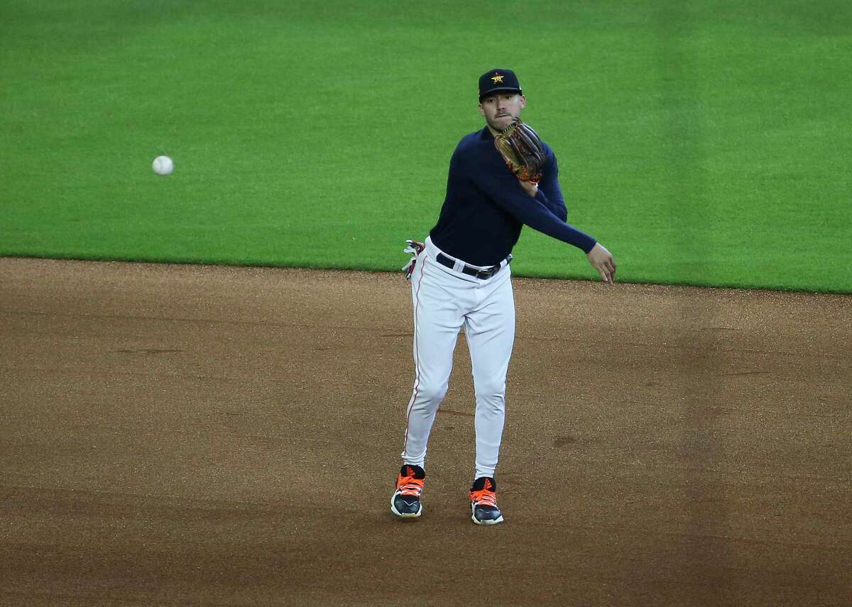 Houston Astros shortstop Carlos Correa throw during a defense drill during the Astros summer camp Sunday, July 5, 2020, at Minute Maid Park in Houston.
