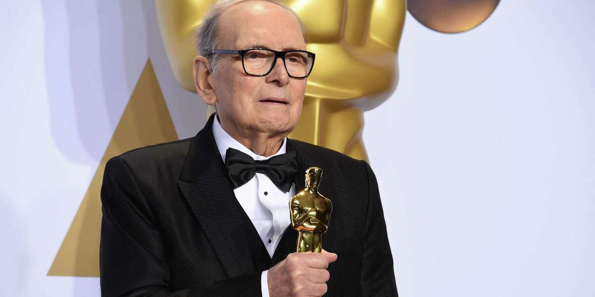 Ennio Morricone poses with his Oscar for best original score for “The Hateful Eight” in 2016. One of the world's best-known and most prolific film composers, Morricone has died in Rome.