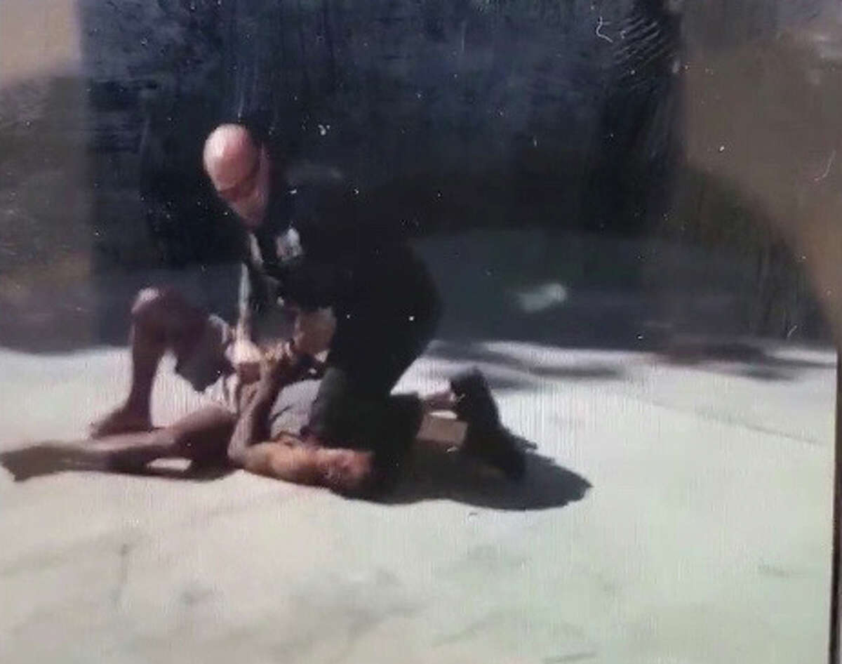 A still image made from a video taken Monday, July 6, shows a Schenectady police officer kneeling on the neck of a suspect.