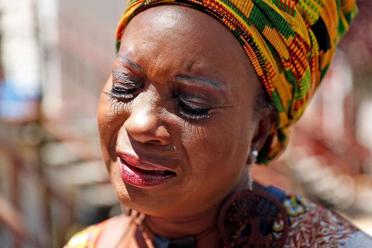 Asale-Haquekyah Chandler, the mother of Yalani Chinyamurindi, who was fatally shot in 2015, gets emotional after laying flowers and lighting a candle at the scene of the July 4th fatal shooting of 6-year-old Jace Young on Whitfield Court in San Francisco, Calif., on Monday, July 6, 2020.