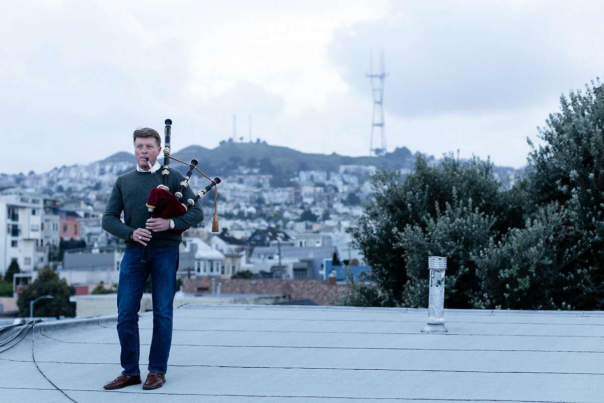 Bagpiper Hal Wilkes plays his 75 years old bagpipe on his building�s rooftop as the shelter-in-place order remains in effect to slow the spread of the coronavirus pandemic on Friday, March 27, 2020, in San Francisco, Calif.