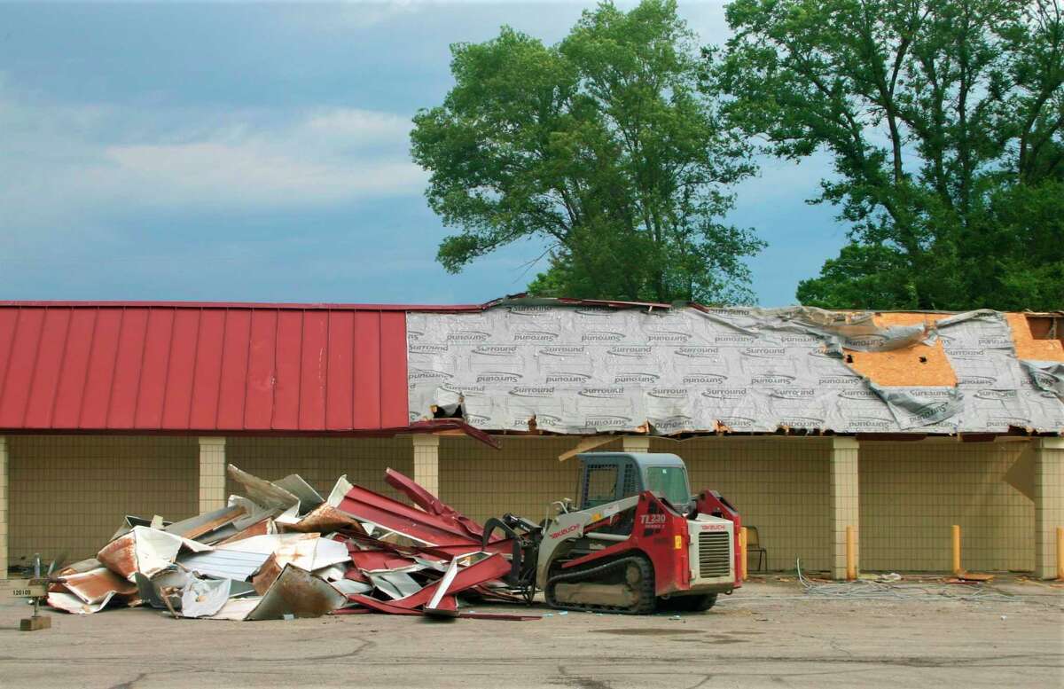 Materials from inside the old Vic's Supermarket are hauled away in preparation for its demolition. Gerber Construction of Reed City began demolishing the old structure this week. The new Ebels Supermarket is expected to open in February 2021. (Herald Review photo/Cathie Crew)