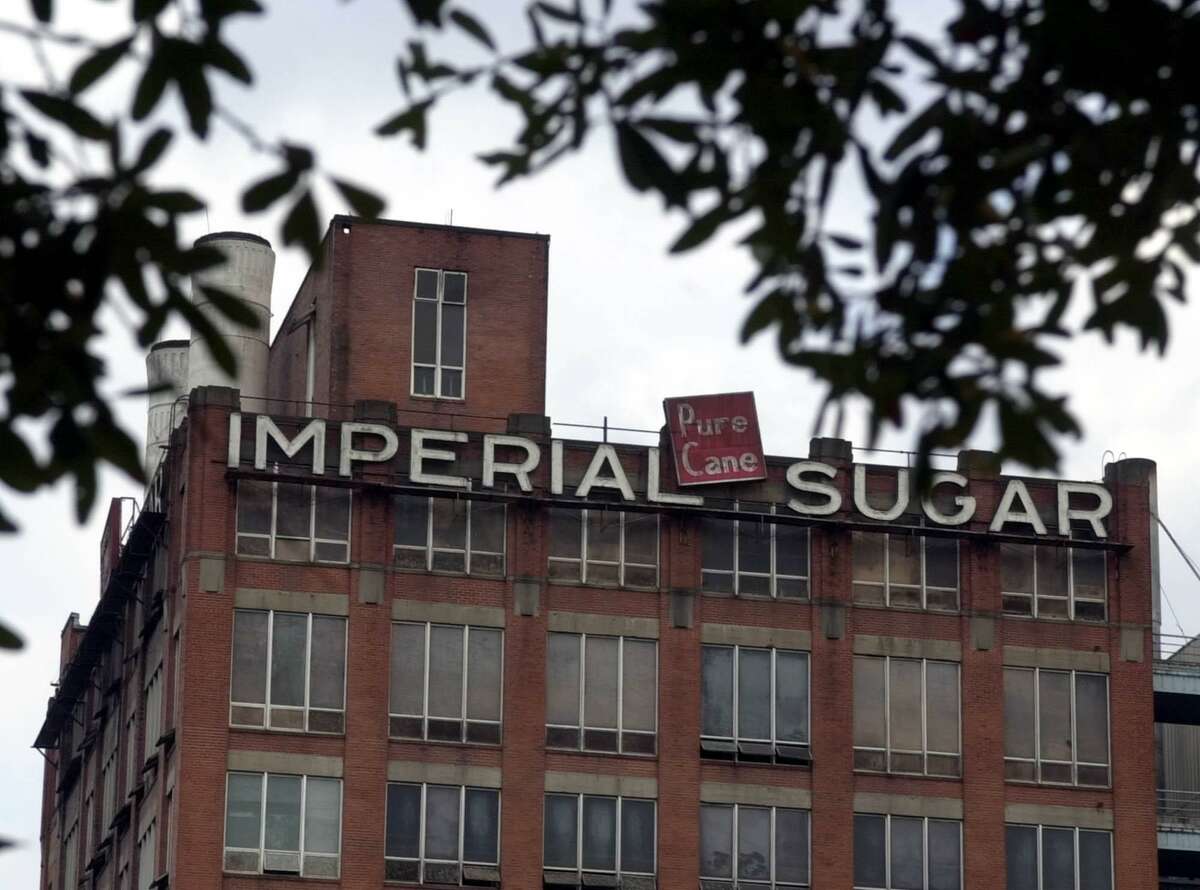 The old Imperial Sugar refinery is seen Wednesday, Dec. 18, 2002, in Sugar Land, Texas. The 158-year-old company that gave this Houston suburb its sweet name stopped growing sugar cane a stone's throw from its operations in the days of flappers. Now Imperial Sugar, one of the state's oldest corporations still operating at its original site, has shut down its 77-year-old refinery that used to process up to 3 million pounds of granulated, brown and powdered sugar each day.
