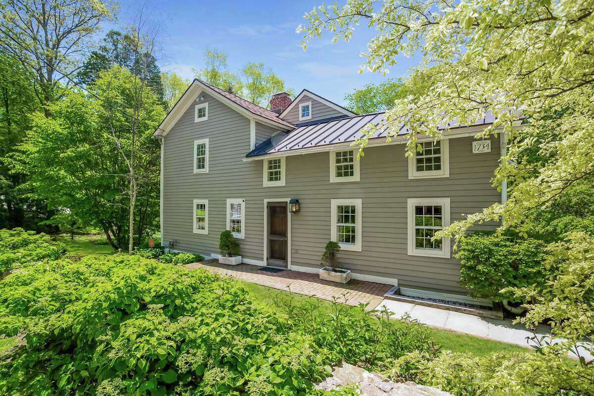 A flagstone and red brick path leads to the tan-colored, updated antique colonial house at 3435 Morehouse Highway, which was built in 1734. This house is within walking distance to Morehouse Egg Farm, and hiking trails in the municipal open space by Morehouse Brook, as well as Lake Mohegan. It is also just a very short drive to H. Smith Richardson golf course. Other nearby amenities that the residents of this house can take advantage of are many Easton farms in one direction and the Merritt Parkway in the other, as well as shopping and restaurants along Black Rock Turnpike.