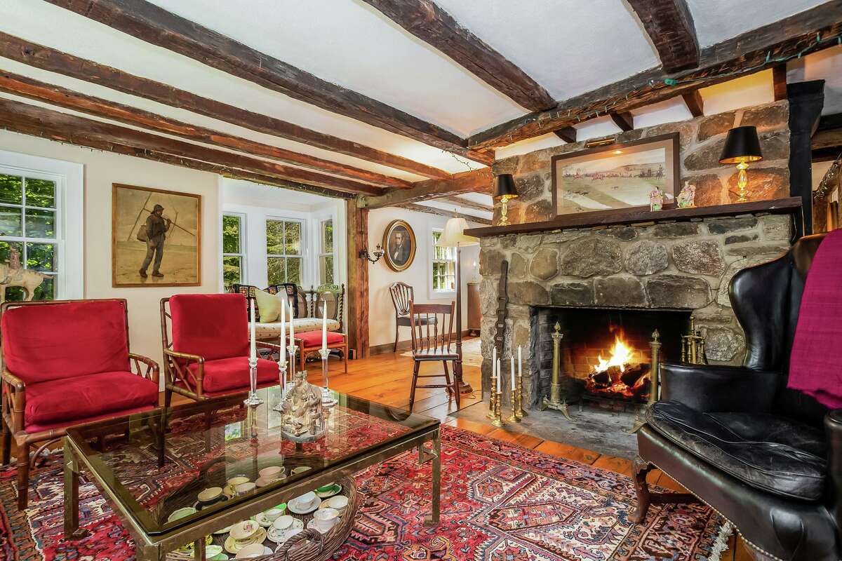 The living room features a stone fireplace, exposed posts and beams and wide-board flooring. “The destruction wreaked by the British was extensive and had lasting impacts on Fairfield’s economy and development. Within the Four Squares, only six houses survived the burning,” according to the Fairfield Museum and History Center website. To get a glimpse of this house, prospective buyers have to pay close attention. As the co-listing agents say, the street numbers in this neighborhood are strange because on one side of the roadway is Morehouse Highway in Fairfield and on the other side is Morehouse Road in Easton.