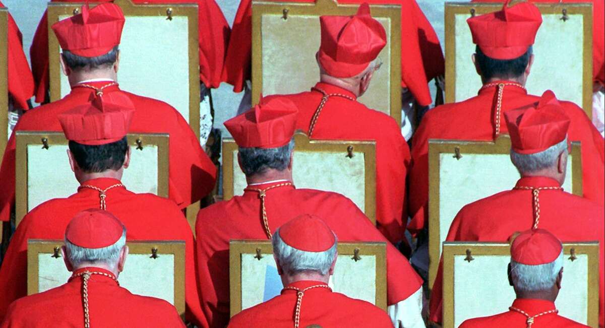Old cardinals are seen during a 1998 Vatican City ceremony during which Pope John Paul II urged them to help lead the Catholic Church. The cardinal bird is named after the clergymen for their red crests and plumage, which resembles the red caps and robes of the clergymen.
