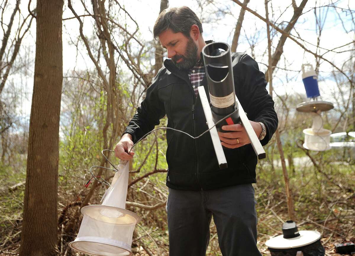 Scientist John Shepard, of the Connecticut Agricultural Experiment Station in New Haven, puts out a variety of mosquito traps on Land Conservation Trust property in Milford on April 18, 2018.