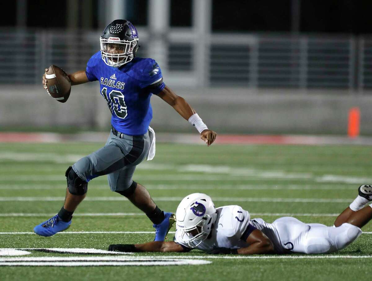 New Caney's QB Jordan Cooper (10) tries to shake off Dayton's Hedil Cuatianquiz (15) during the first half of a high school fiootball game at Texan Drive Stadium, Friday, Sept. 29, 2017, in Porter. ( Karen Warren / Houston Chronicle )