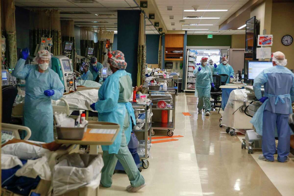 Healthcare workers work to treat critically ill patients filling bed after bed in the Parkland Hospital COVID-19 Tactical Care Unit on June 27, 2020, in Dallas. (Ryan Michalesko/Dallas Morning News/TNS)