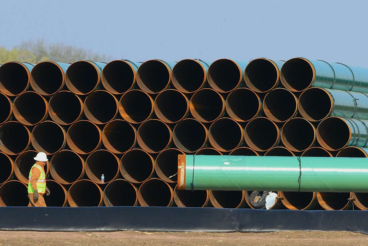 Pipes for the Dakota Access oil pipeline, that stretches from the Bakken oil fields in North Dakota to Patoka, Ill., are stacked Saturday, May 9, 2015, at a staging area in Worthing, S.D.