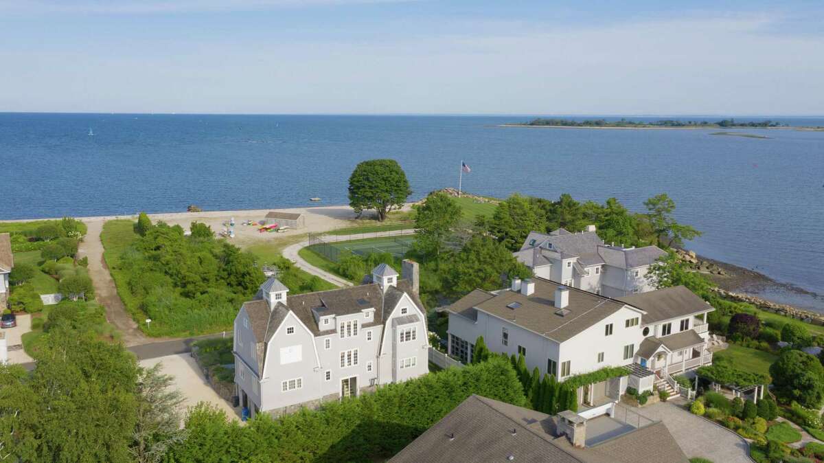 This house is only steps from a private community beach for residents of Saugatuck Island. In the two-story great room there is a floor-to-ceiling stone fireplace, built-in bookshelves, and another built-in window seat. The spacious gourmet kitchen features a long center island/breakfast bar, two-story vaulted ceiling, high-end appliances, a pantry, and a built-in window seat. Are you getting the sense that this house really was built, in 2004, for comfort and casual living and entertaining?