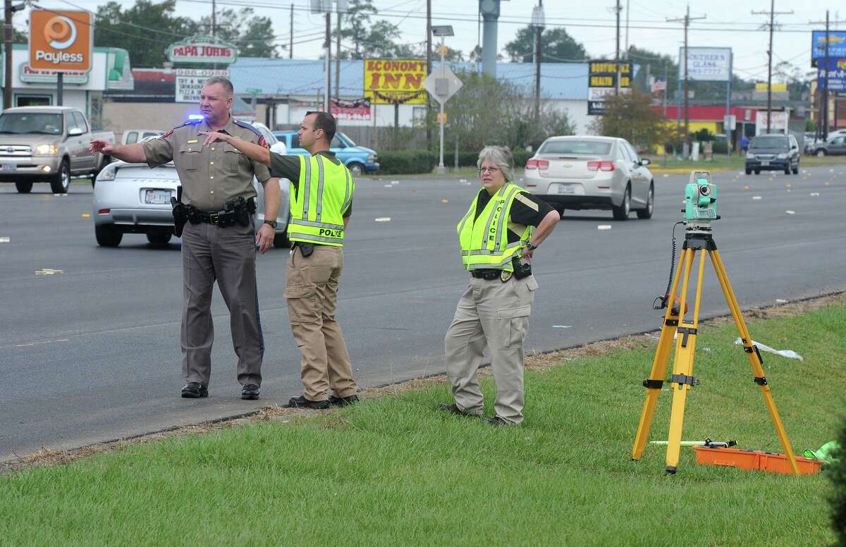 Orange Police and the Texas State Troopers examine the scene of Monday's hit and run that killed a 25-year-old woman and her 5-year-old daughter on MacArthur Drive in Orange. Photo taken Tuesday, November 3, 2015 Guiseppe Barranco/The Enterprise