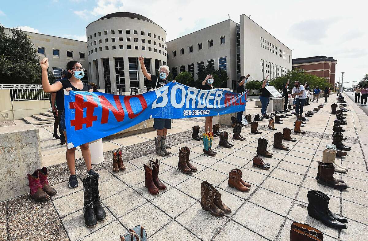 Boots and shoes of those that cannot be present are placed on the ground as the #NoBorderWall Laredo Coalition holds a demonstration outside the George P. Kazen Federal Building and United States Courthouse, Tuesday, Jul 7, 2020, to protest the building of a border wall in Laredo.