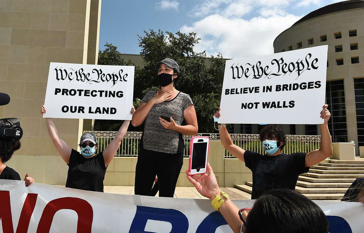 and shoes of those that cannot be present are placed on the ground as the #NoBorderWall Laredo Coalition, which includes residents and land owners, holds a demonstration outside the George P. Kazen Federal Building and United States Courthouse, Tuesday, Jul 7, 2020, to protest the building of a border wall in Laredo.