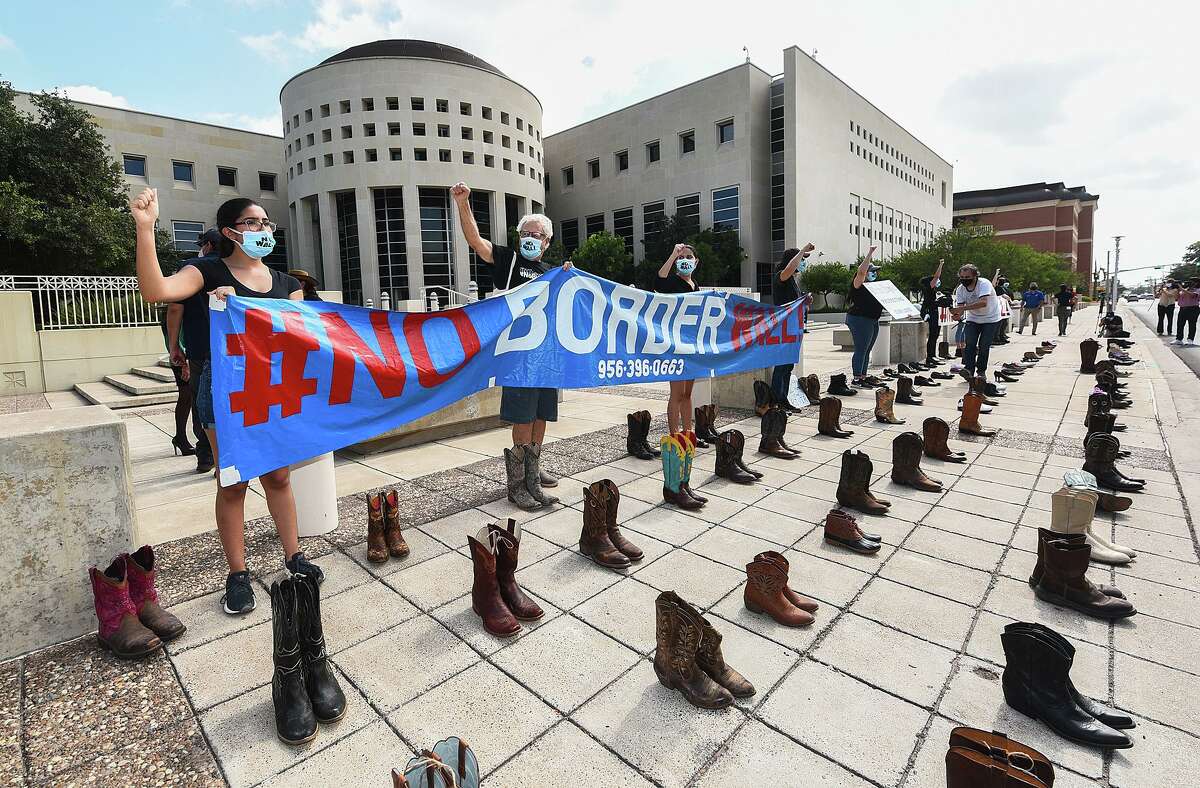 Boots and shoes of those that cannot be present are placed on the ground as the #NoBorderWall Laredo Coalition holds a demonstration outside the George P. Kazen Federal Building and United States Courthouse, Tuesday, July 7, 2020, to protest the building of a border wall in Laredo.