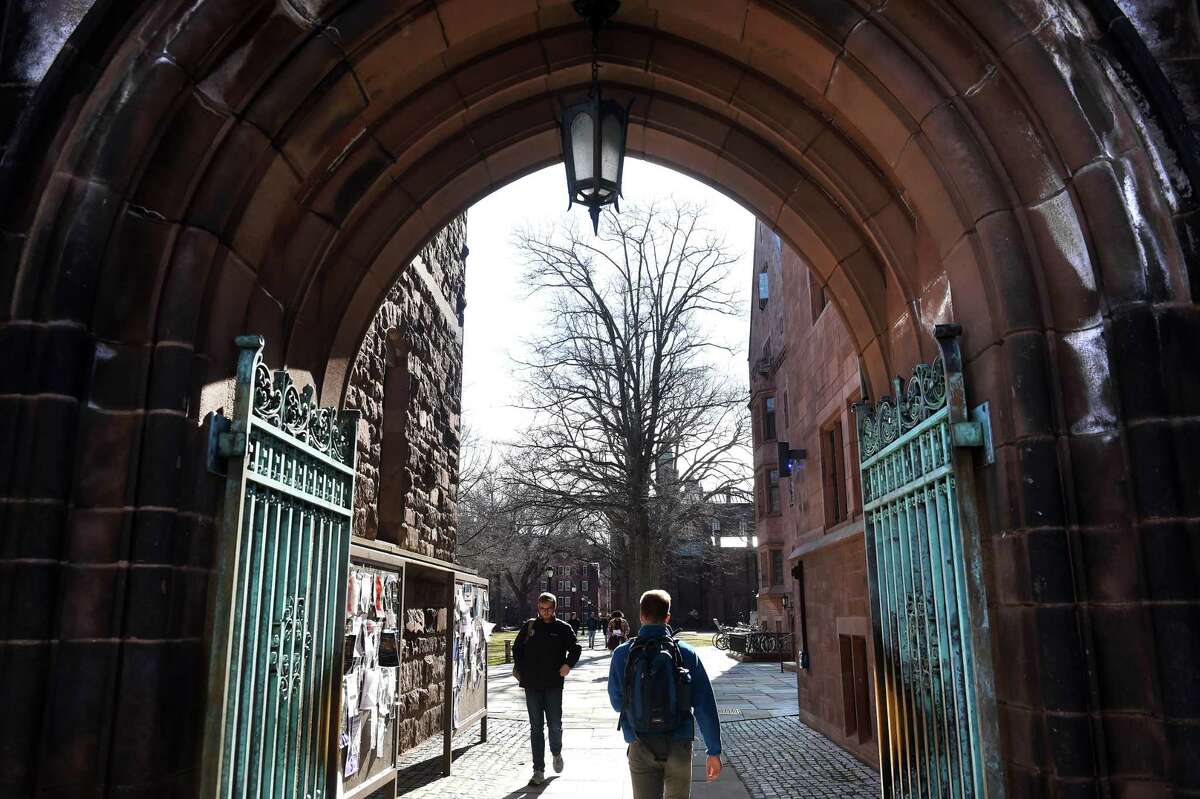 Students walk through an entrance to Yale University’s Old Campus in New Haven on March 5.