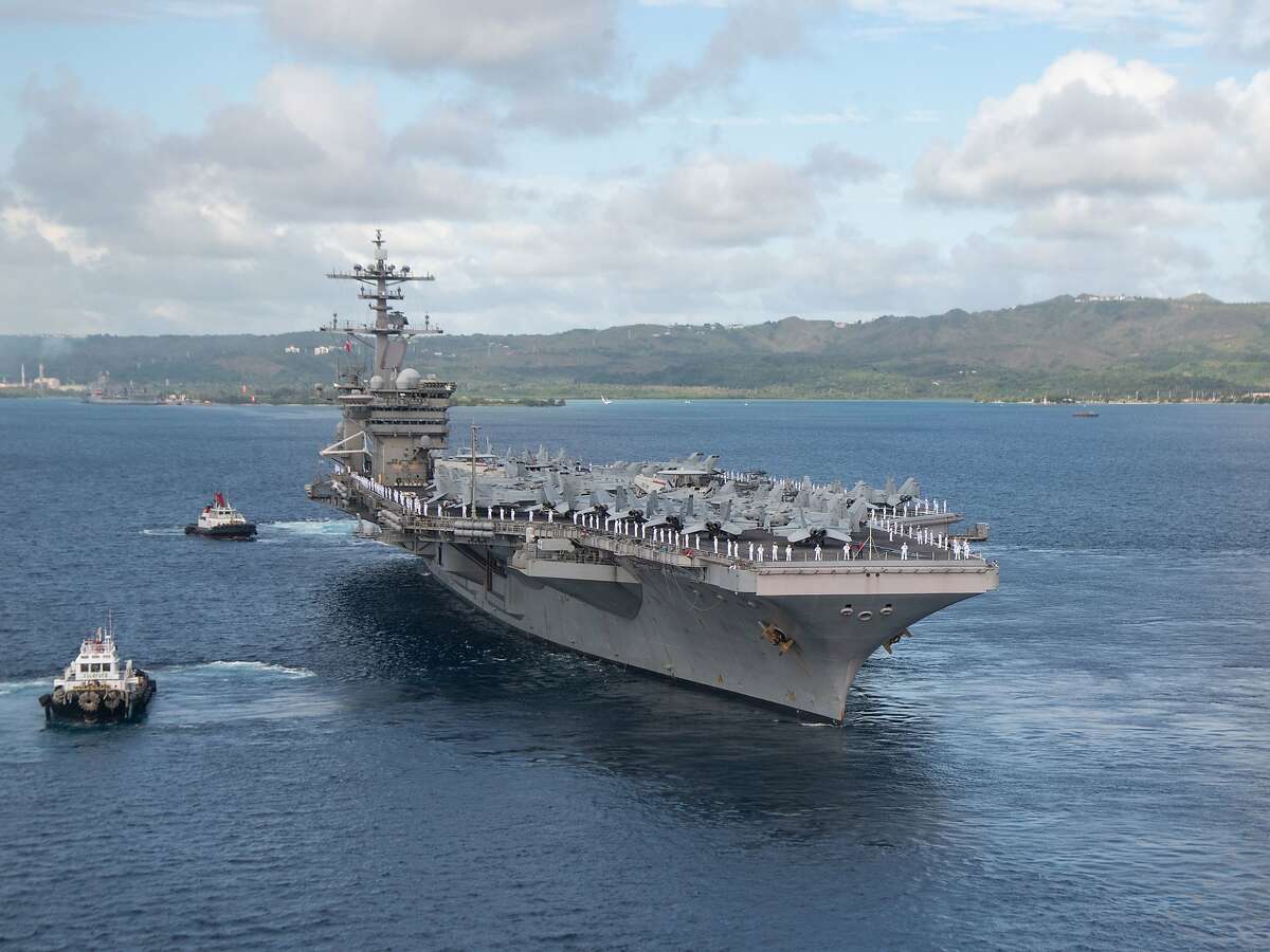 200604-N-LH674-1353 NAVAL BASE GUAM (June 4, 2020) Sailors man the rails as the aircraft carrier USS Theodore Roosevelt (CVN 71) departs Apra Harbor, June 4, 2020. Following an extended visit to Guam in the midst of the COVID-19 global pandemic, Theodore Roosevelt is returning to operational tasking during a deployment to the Indo-Pacific. (U.S. Navy photo by Mass Communication Specialist Seaman Kaylianna Genier/Released)