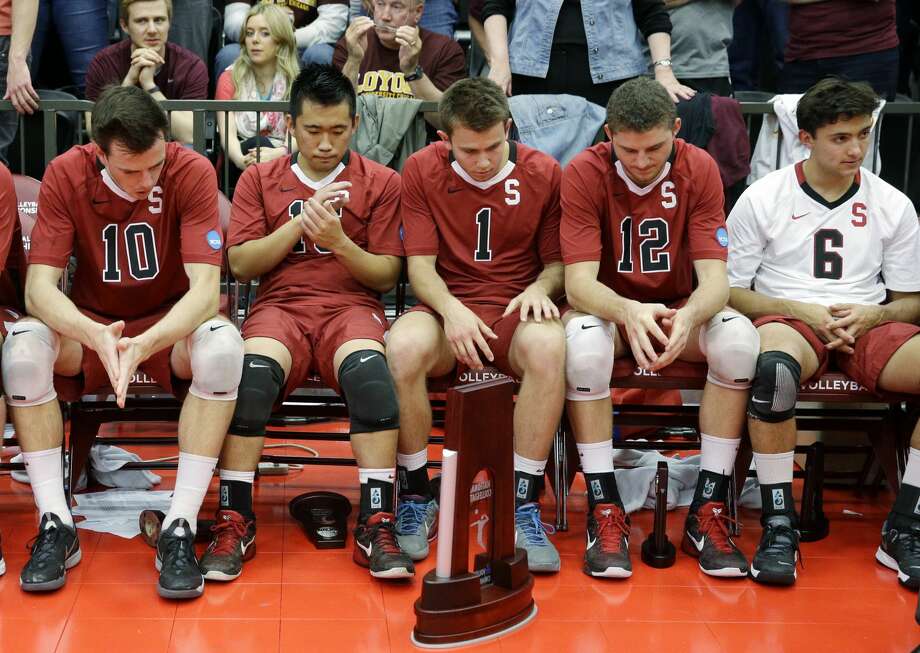 In this file photo, Stanford men's volleyball players react after losing the 2014 NCAA men's college volleyball championship. The sports program is one of 11 that the school is eliminating after the 2020-21 academic year. Photo: Nam Y. Huh/AP