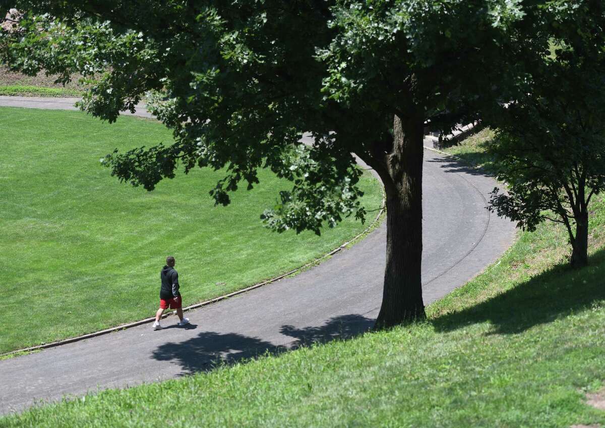 A man takes laps on the track at Havemeyer Park in Greenwich, Connecticut on Monday, July 6, 2020. The city has opened playgrounds and basketball courts for use this week after months of closure due to the coronavirus .