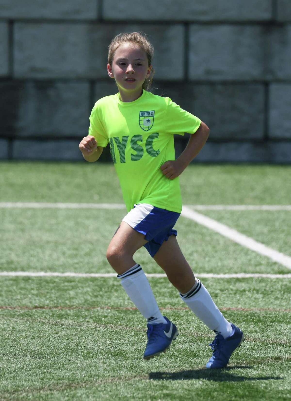 Callie Smith, 8, plays kickball during Cardinal Football Camps at Cos Cob Park in the Cos Cob section of Greenwich, Connecticut on Monday, July 6, 2020. The city has opened playgrounds and basketball courts to use this week after months of coronavirus shutdown.