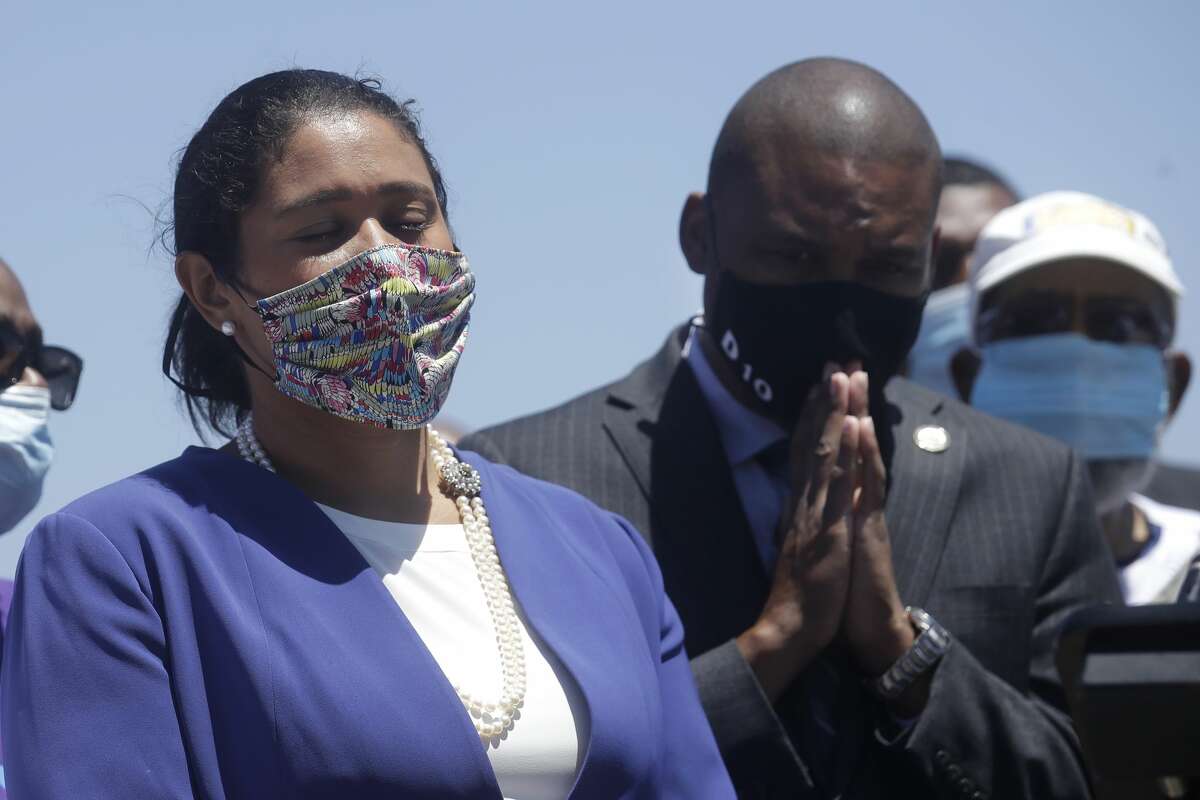 Mayor London Breed, left, and Supervisor Shamann Walton listen at a news conference about the shooting death of Jace Young in San Francisco, Tuesday, July 7, 2020.