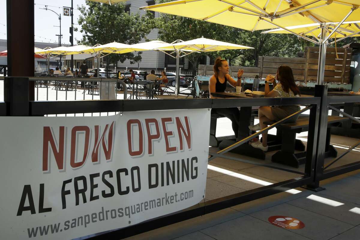 People eat outdoors at San Pedro Square on Monday, July 6, 2020, in San Jose, Calif. The Independence Day weekend saw one of Santa Clara County's largest increases in COVID-19 cases to date, which came as the state of California denied the county's application for further reopening of businesses and activities.