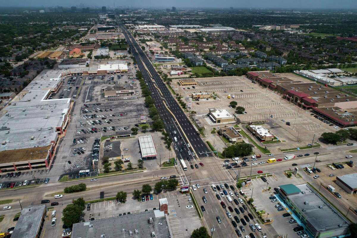 The contrast between a newly resurfaced Westheimer Road and the old surface is visible at the intersection with Dairy Ashford, seen July 8, 2020, in west Houston. Crews with Angel Brothers switched to a 24-hour cycle to take advantage of lower traffic and basically cut the construction time in half.