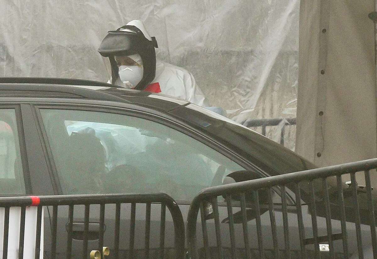 File photo of a person getting tested at a drive-thru COVID-19 testing site in Stamford, Conn., on March 20, 2020.