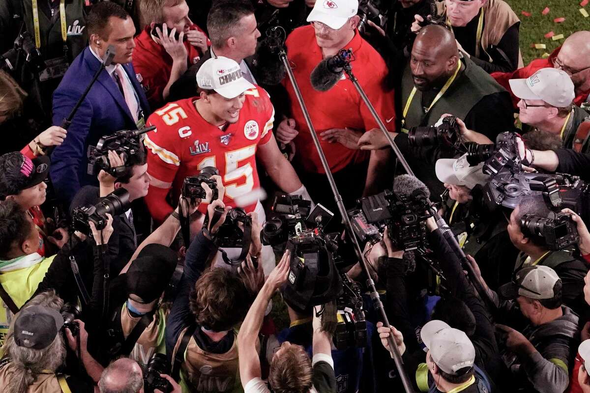 FILE - In this Feb. 2, 2020, file photo, Kansas City Chiefs quarterback Patrick Mahomes (15) is surrounded by media after his team won the NFL Super Bowl 54 football game against the San Francisco 49ers, in Miami Gardens, Fla. As sports prepare to resume, journalists are facing the same reckoning that their colleagues who cover politics, education and entertainment have encountered a€?