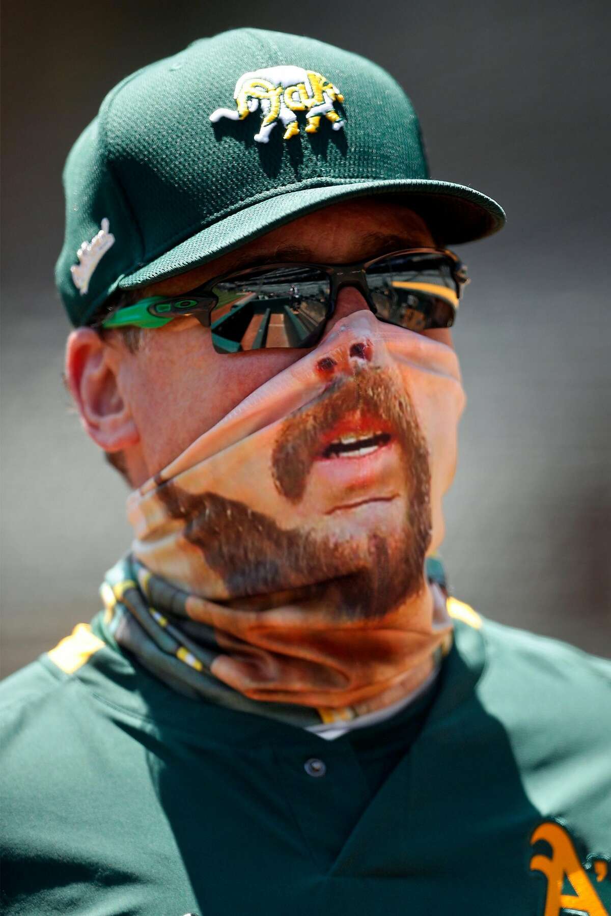 Oakland Athletics' manager Bob Melvin wears a mask imprinted with an image of pitcher Mike Fiers during practice at Oakland Coliseum in Oakland, Calif., on Wednesday, July 8, 2020.