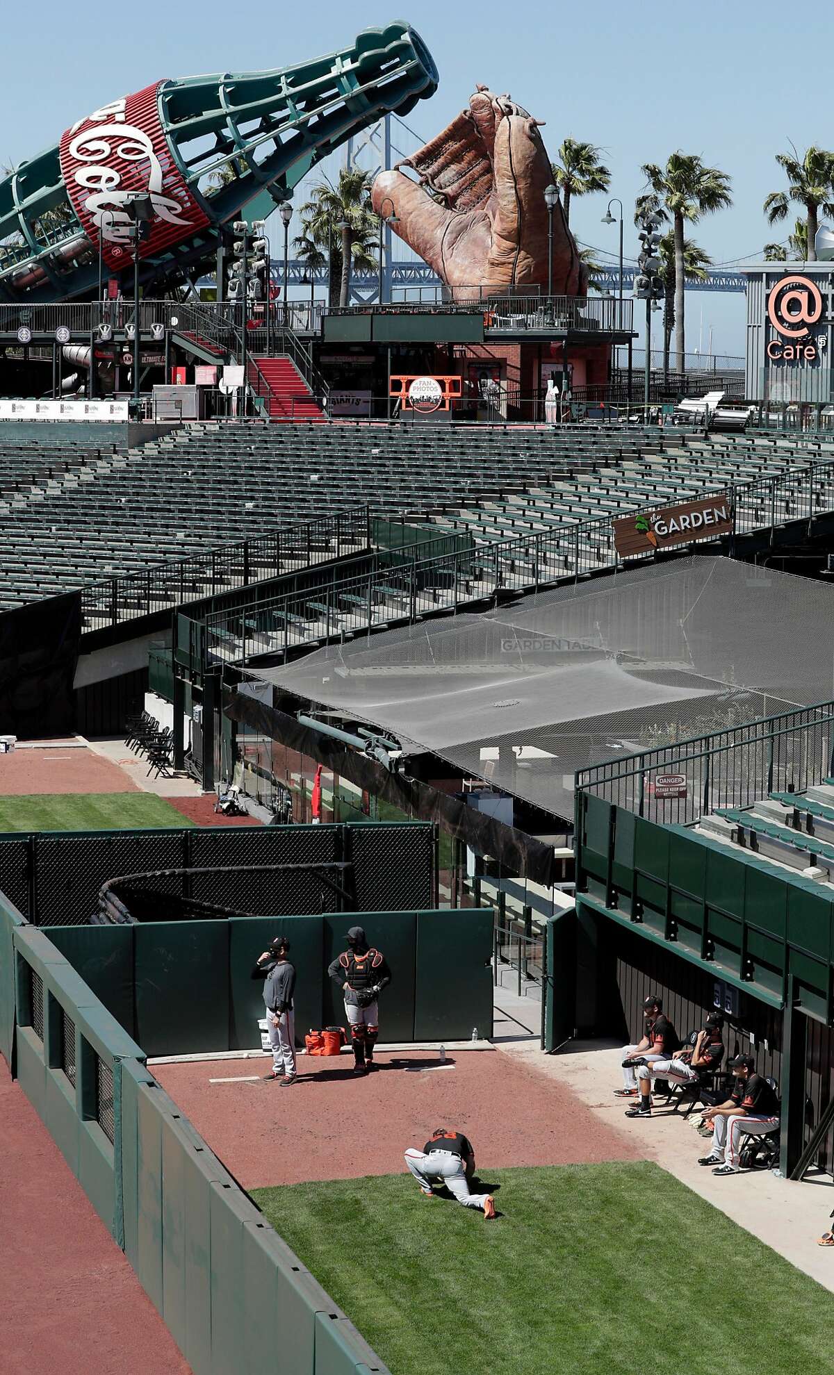 Relief pitchers warm up in the new outfield bullpen as the San Francisco Giants worked out and played a simulated game at Oracle Park in San Francisco, Calif., on Wednesday, July 8, 2020.