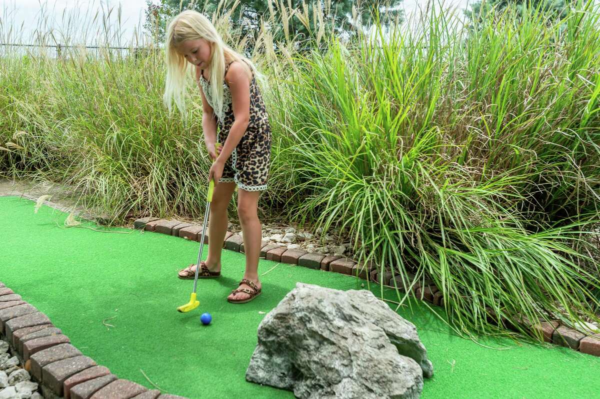 Eight-year-old Alise Martin putts through one of the tunnel obstacles on the course. Colorado Canyon has undergone some improvements recently including new surfaces on many of their greens, and more will be replaced in the future. Photo made on July 5, 2020. Fran Ruchalski/The Enterprise