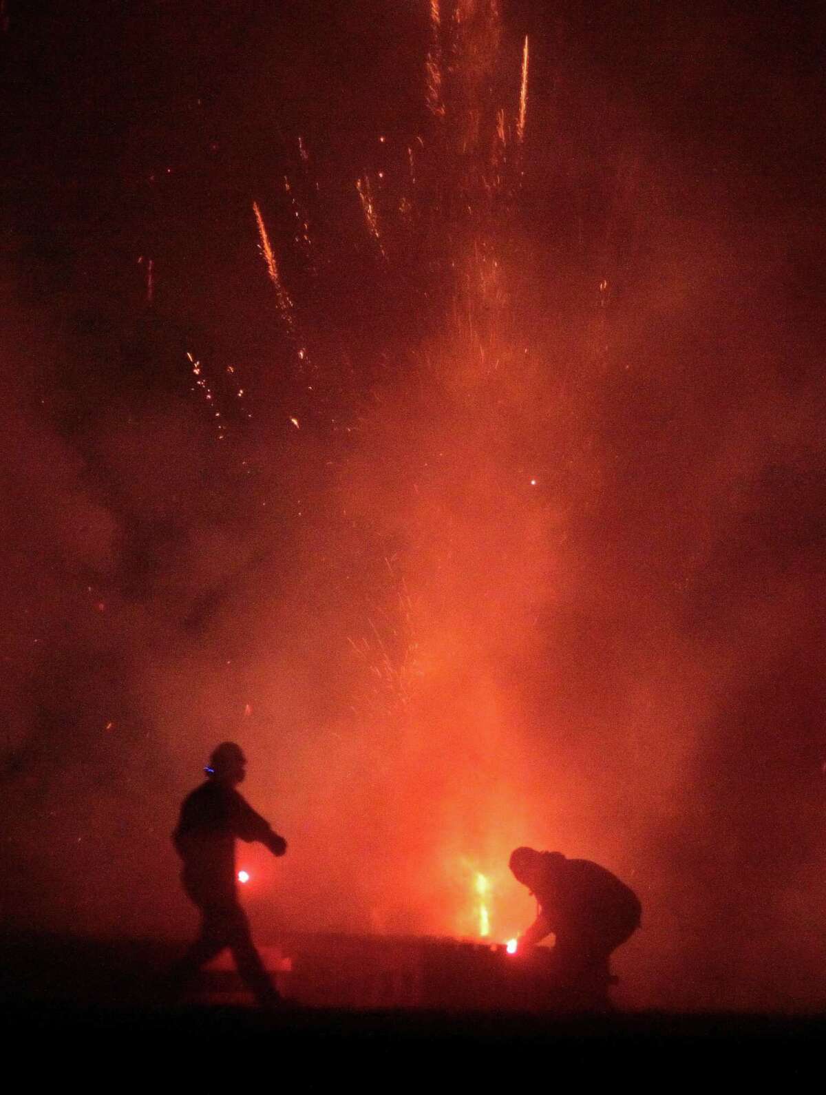 The July 4th holiday fireworks display is held at Veterans Memorial Park in Shelton, Conn., on Wednesday July 8, 2020. Due to the coronavirus pandemic, crowds weren't allowed to gather in the park, but were able to watch from the roads and homes nearby.