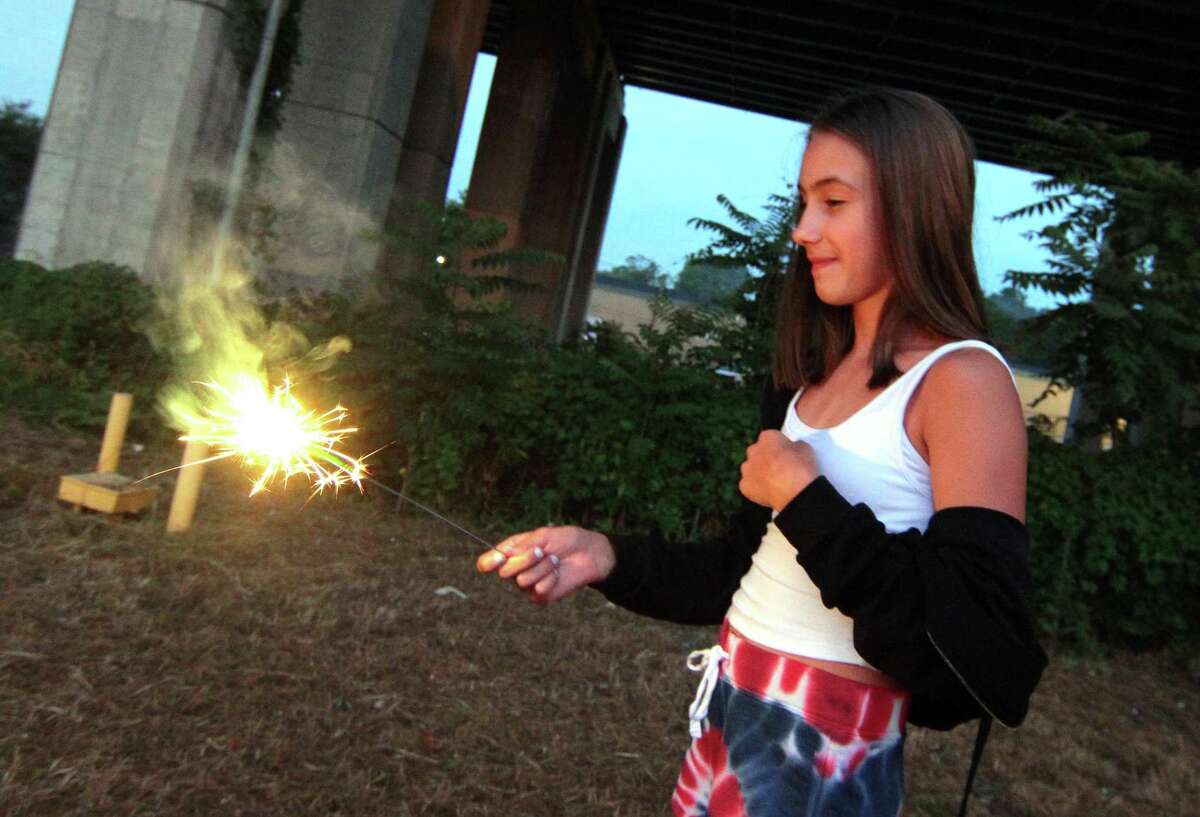 The July 4th holiday fireworks display is held at Veterans Memorial Park in Shelton, Conn., on Wednesday July 8, 2020. Due to the coronavirus pandemic, crowds weren't allowed to gather in the park, but were able to watch from the roads and homes nearby.