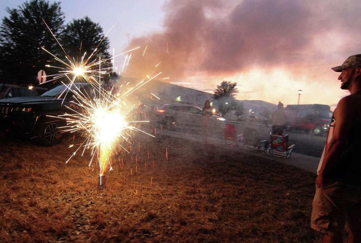 People participate in a July 4th holiday fireworks display in Shelton, Conn. on Wednesday, July 8, 2020. 