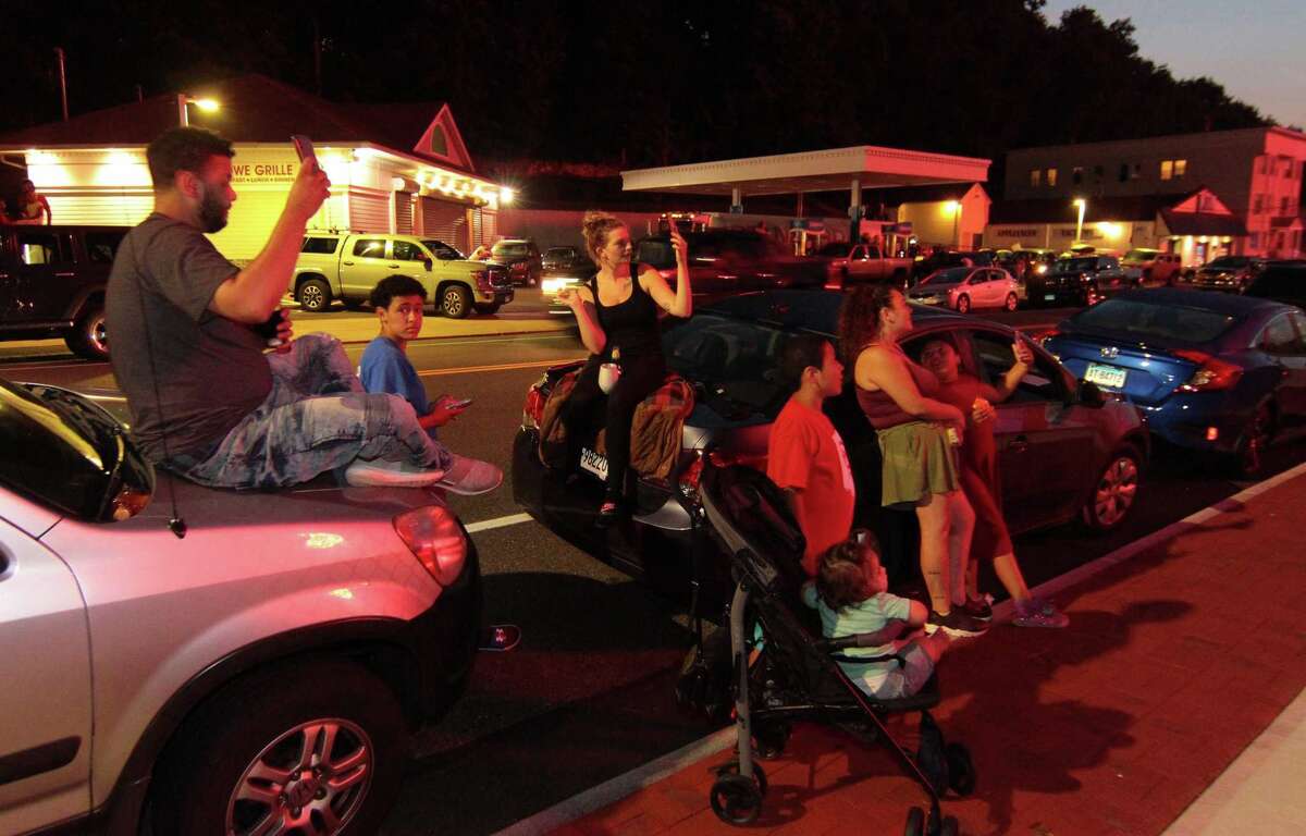 The July 4th holiday fireworks display is held at Veterans Memorial Park in Shelton, Conn., on Wednesday July 8, 2020. Due to the coronavirus pandemic, crowds weren't allowed to gather in the park, but were able to watch from the roads and homes nearby.