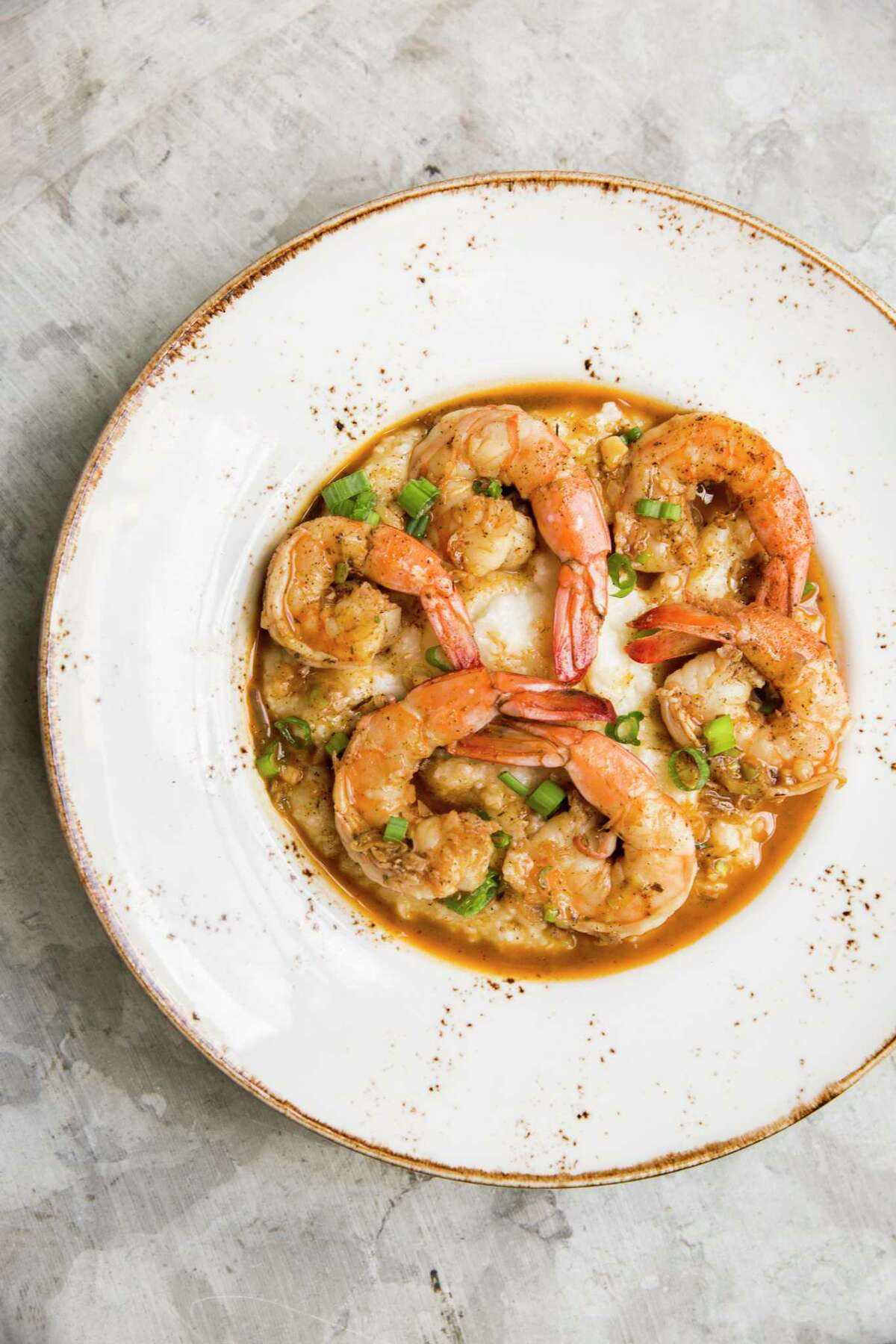 New Orleans-style barbecue shrimp over stone-ground grits at State Fare Kitchen & Bar, opening a new location this summer in Sugar Land.