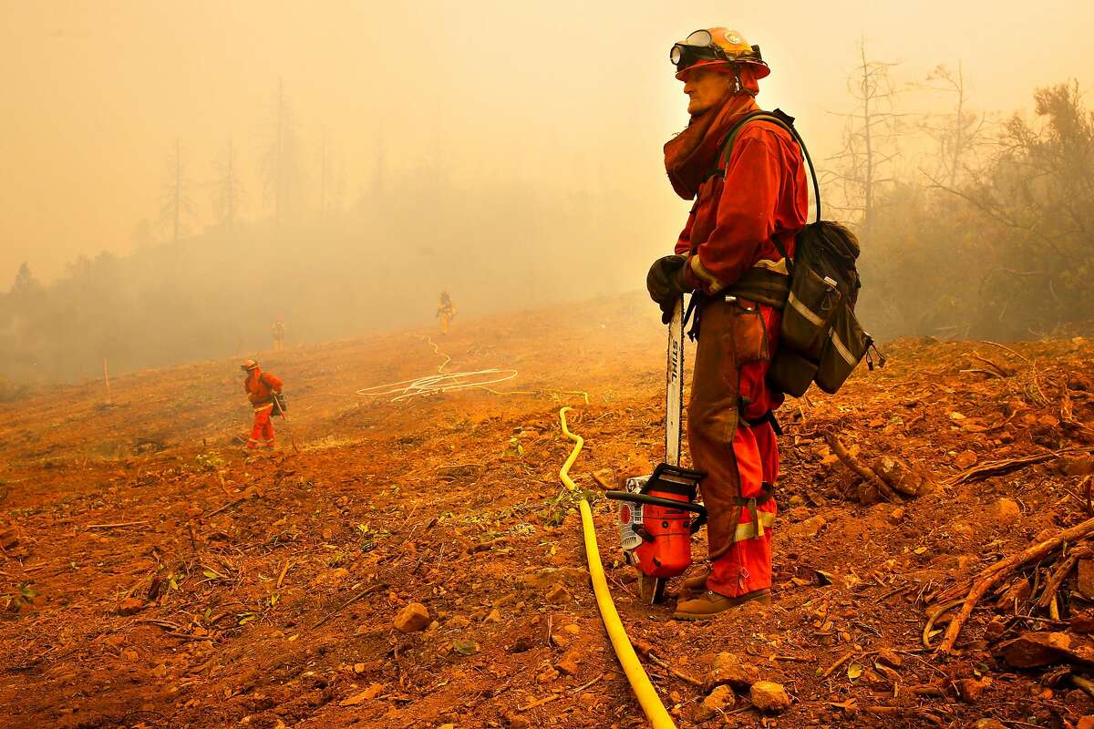 Jeremy Roberson an inmate firefighter with the Cal Fire McCain Valley crew keeps watch on hot spots as firefighters continue to battle the Detwiler Fire on the outskirts of Mariposa, Ca., on Wednesday July 19, 2017.