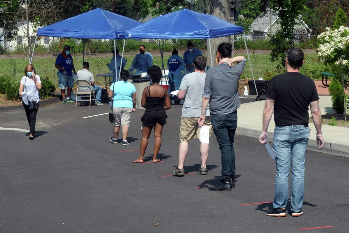 Hundreds of people turned out Thursday morning for COVID-19 tests at Liberation Programs, in Bridgeport, Conn. July 9, 2020. The free community Coronavirus test screenings were administered by the staff of Bridgeport's Southwest Community Health Center.