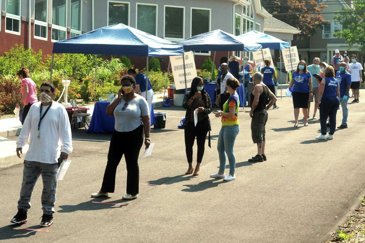Hundreds of people turned out Thursday morning for COVID-19 tests at Liberation Programs, in Bridgeport, Conn. July 9, 2020. The free community Coronavirus test screenings were administered by the staff of Bridgeport's Southwest Community Health Center.