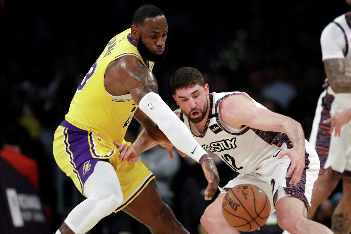 Los Angeles Lakers' LeBron James, left, strips the ball from Brooklyn Nets' Joe Harris during the first half of an NBA basketball game Tuesday, March 10, 2020, in Los Angeles. (AP Photo/Marcio Jose Sanchez)