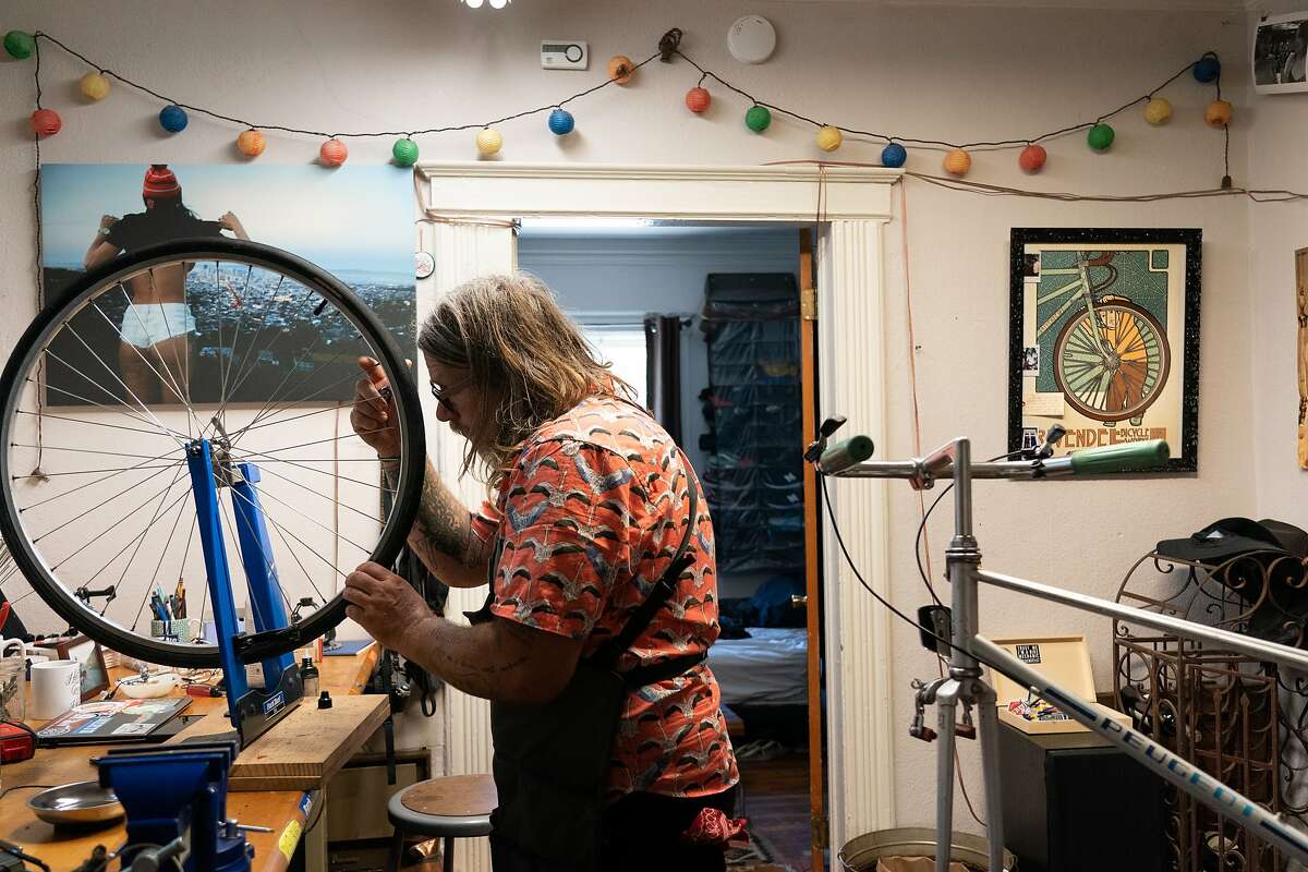 Jay Beaman trues a wheel in his converted dining room as he hopes to get more bicyclists on the road - and more people eager for a future San Francisco that puts bikes over cars on Wednesday, July 8, 2020 in San Francisco, Calif.
